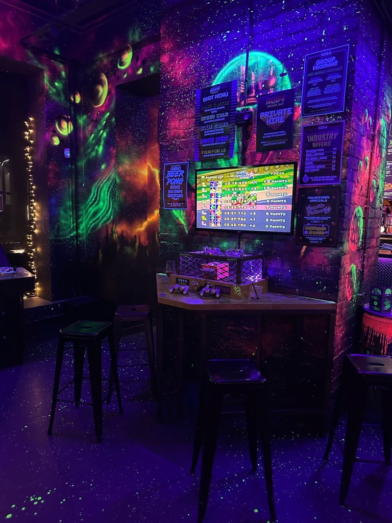 Eye-catching neon graffiti artwork covering the walls of NQ64 Newcastle, creating a bold and immersive retro-gaming atmosphere.