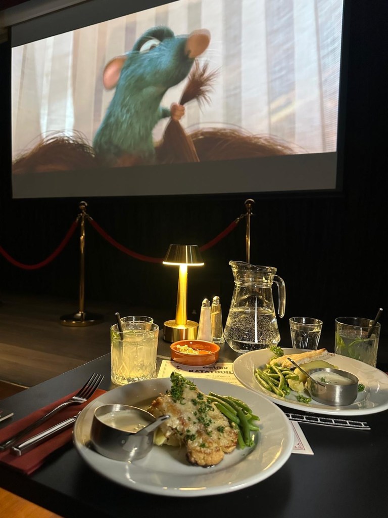 A golden-brown cauliflower steak with creamy potato purée, white truffle sauce, and tender green beans.