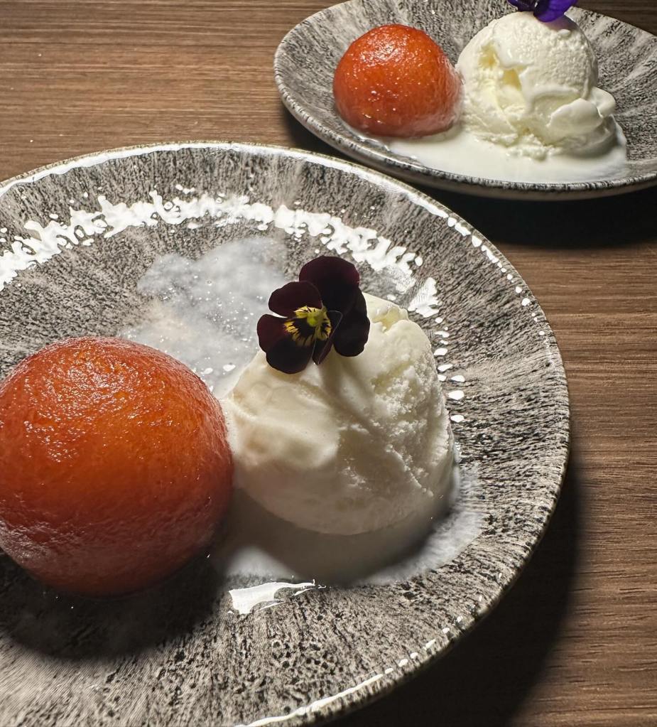 Traditional Indian dessert with sweet dumplings and ice cream scoops at Chakh Dhoom.