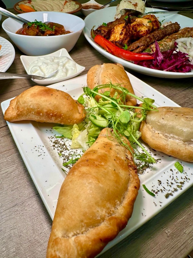 Golden-fried Lebanese sambousek stuffed with melted halloumi and parsley