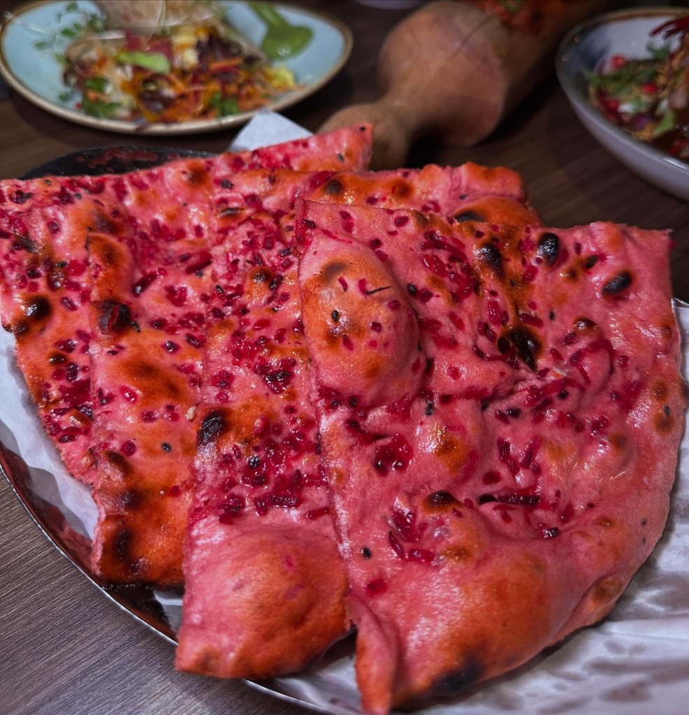 Vibrant beetroot-infused kalonji naan served at Chakh Dhoom, Newcastle.