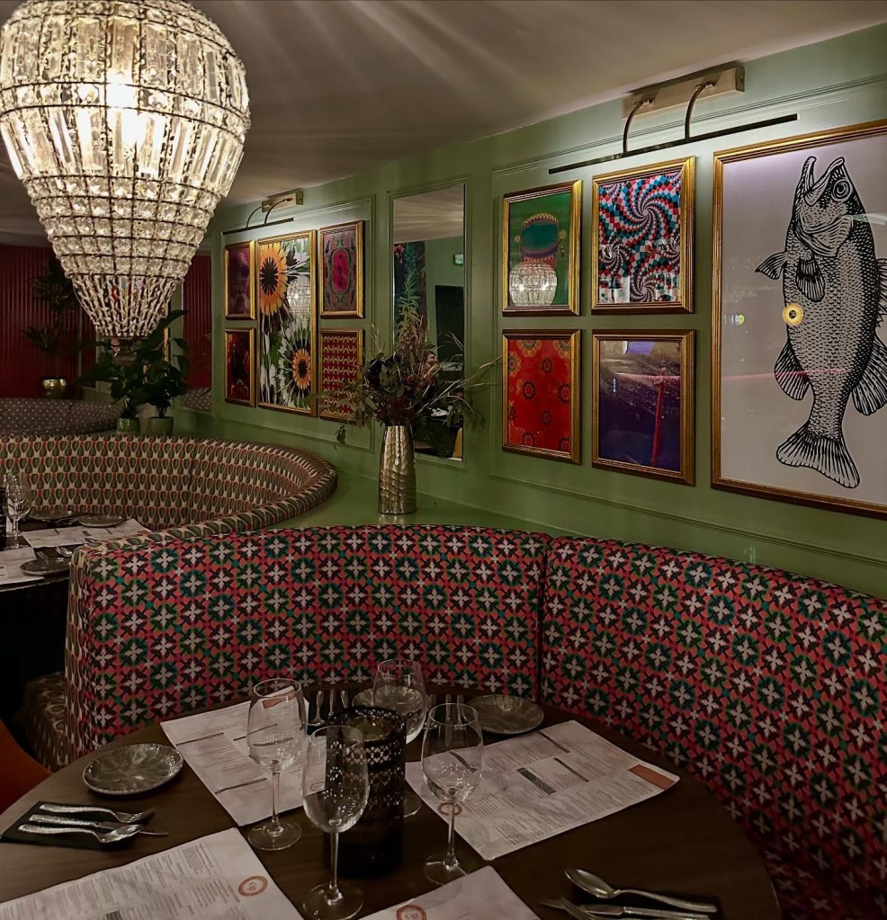 Elegant and vibrant decor at Chakh Dhoom, featuring street food-inspired artwork.