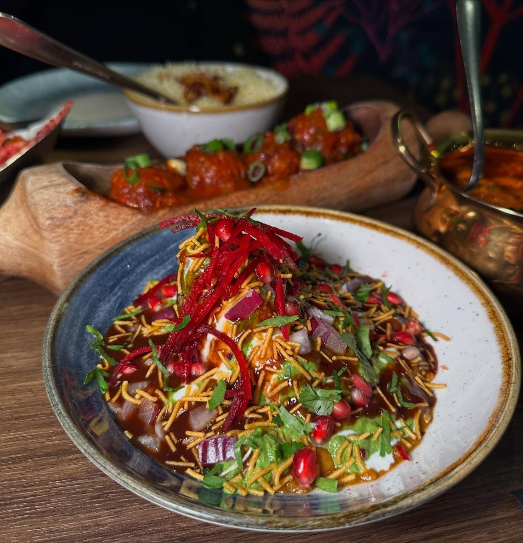 Punjabi Samosa Chaat topped with chickpeas, yoghurt, and chutneys at Chakh Dhoom.