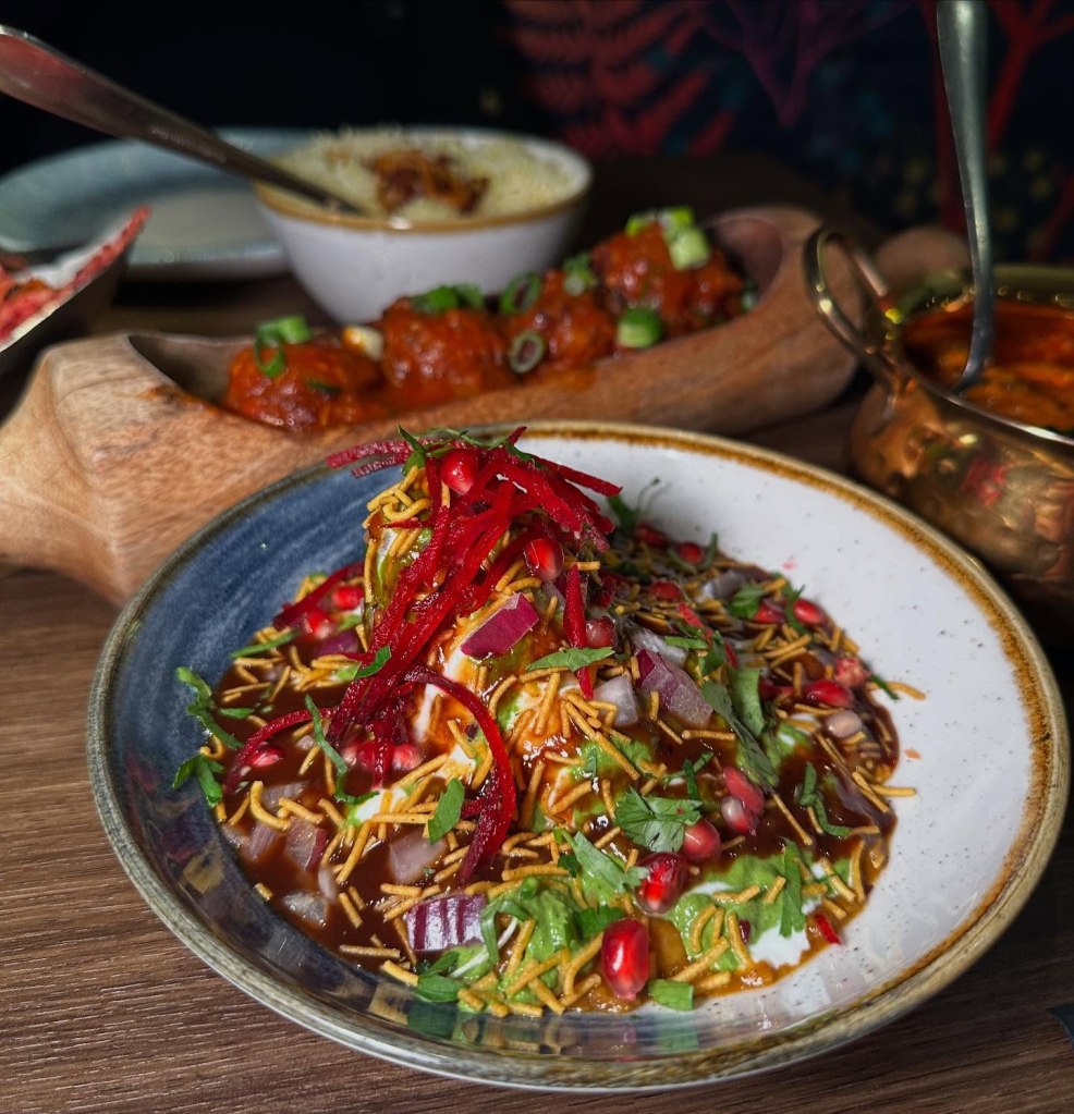 Punjabi Samosa Chaat topped with chickpeas, yoghurt, and chutneys at Chakh Dhoom.