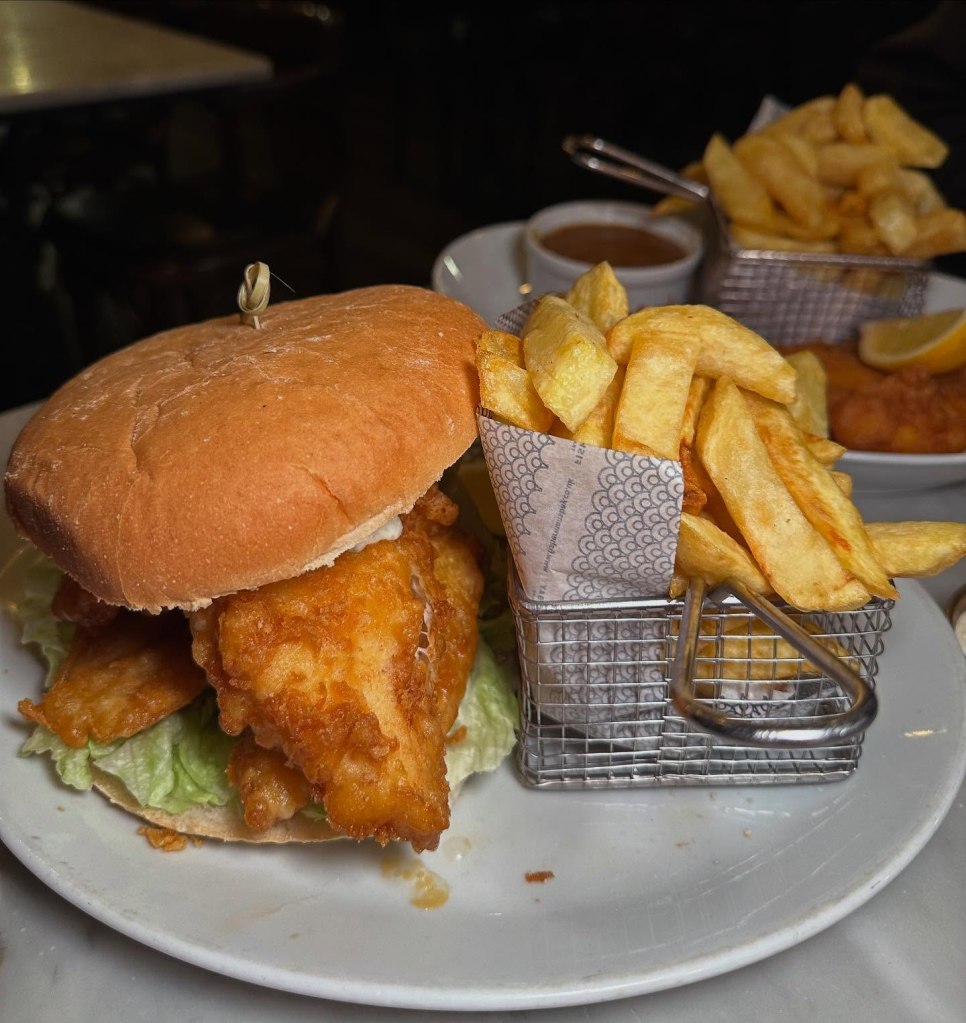 Massive fish finger sandwich with golden crunchy fish, soft bread, and tangy tartar sauce at Fisherman’s Bay.
