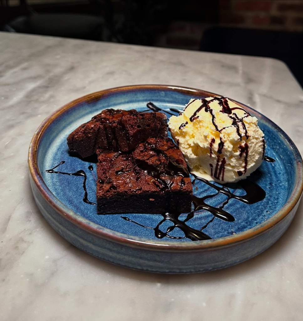 Rich, fudgy brownies served with a generous scoop of ice cream at Fisherman’s Bay.