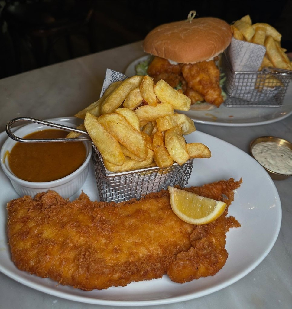 Golden battered cod with crispy, fluffy chips served at Fisherman’s Bay in Whitley Bay.