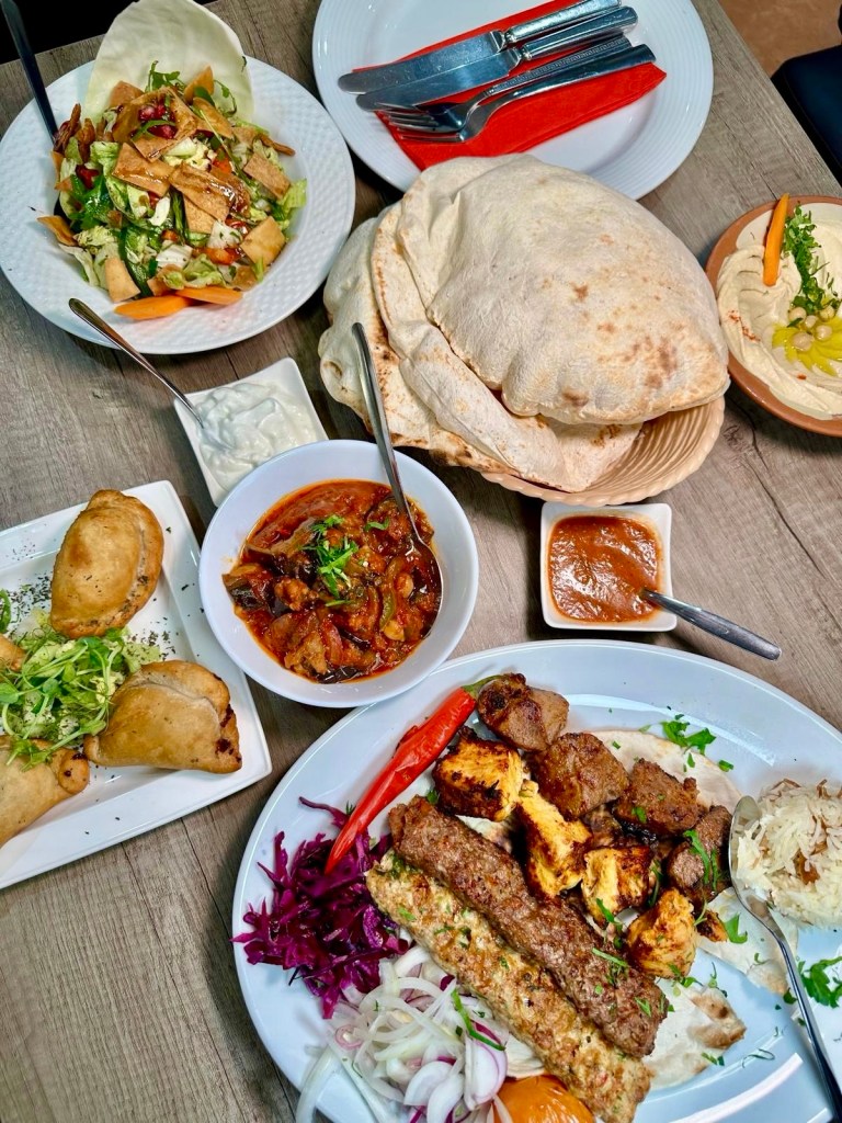 A Lebanese feast at Beyruty with grilled meats, fresh salads, creamy hummus, and flavorful mezze