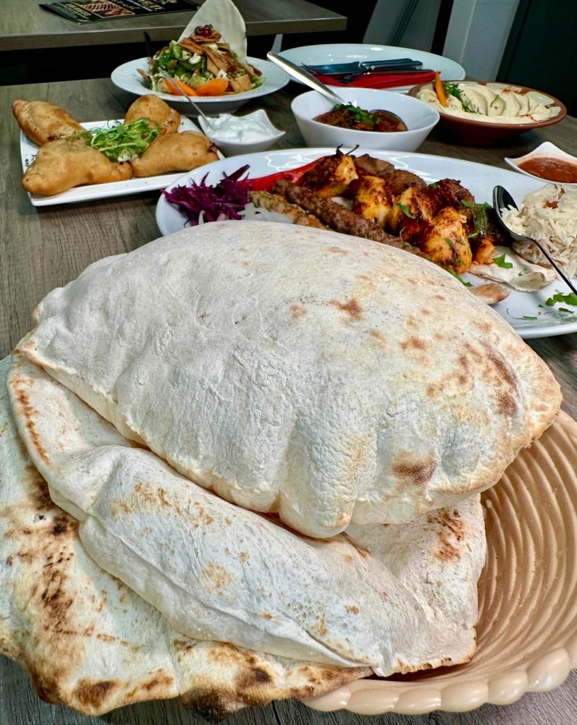 Freshly baked Lebanese bread, soft and warm, served as a side at Beyruty