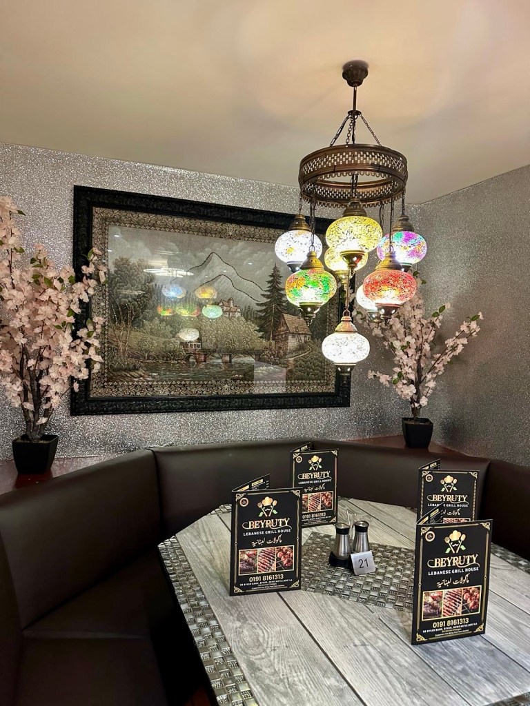 Cozy and casual Lebanese restaurant interior with wooden tables and warm lighting