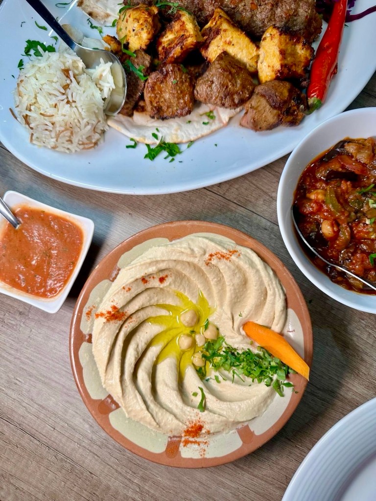 Smooth, creamy hummus served with fresh Lebanese bread at Beyruty.