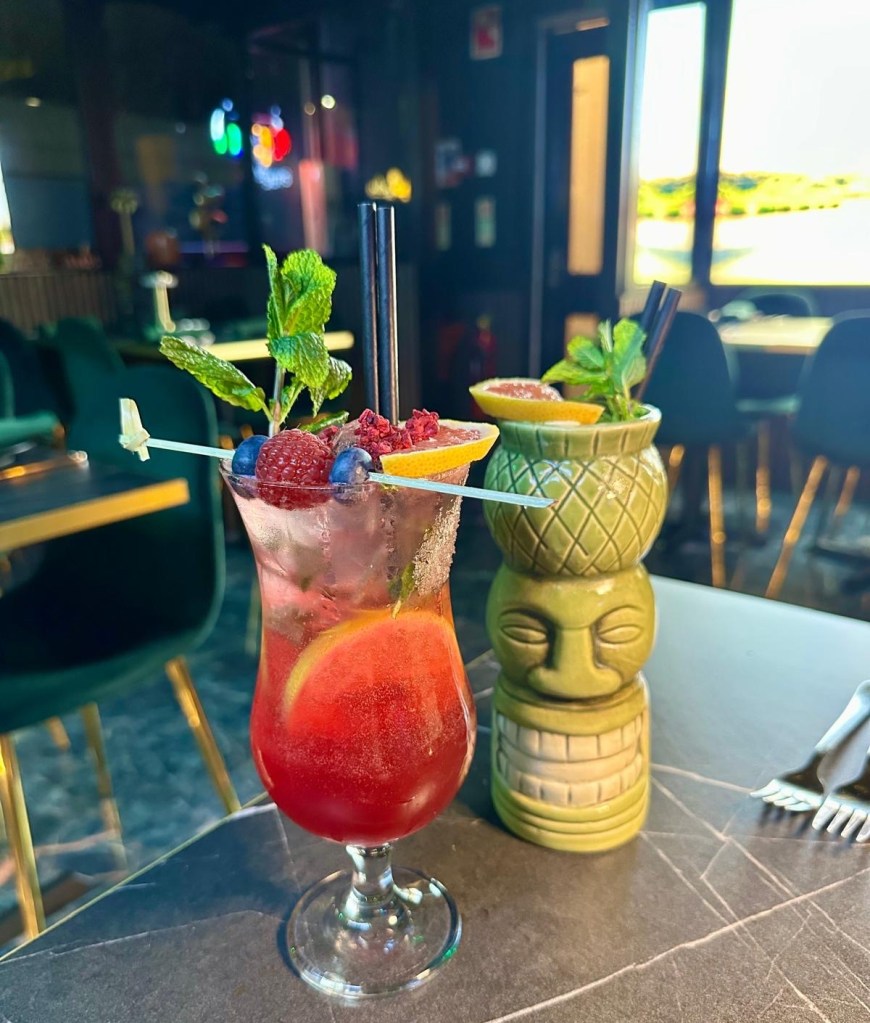 A fruity and refreshing cocktail featuring watermelon, blackcurrant, lime, vodka, and rum and the A creamy and refreshing Mango Lassi cocktail made with vodka, mango, lime, and yogurt.