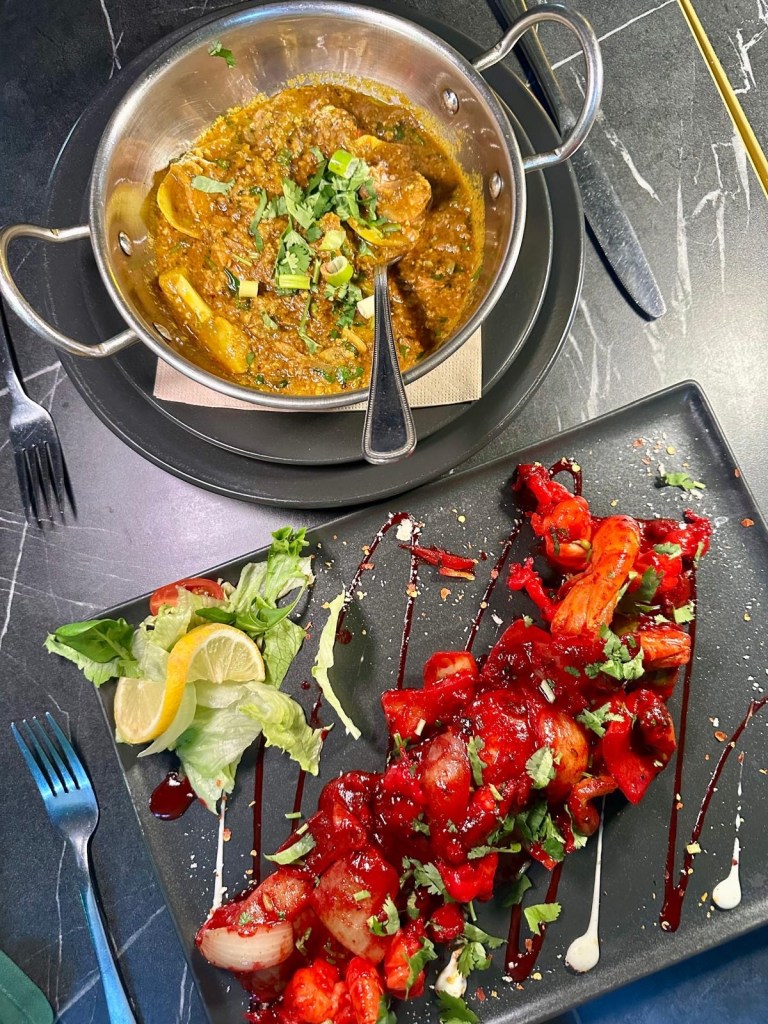 Large king prawns cooked with tamarind, garlic, honey, chili, and turmeric, served with warm, thin bread for dipping.