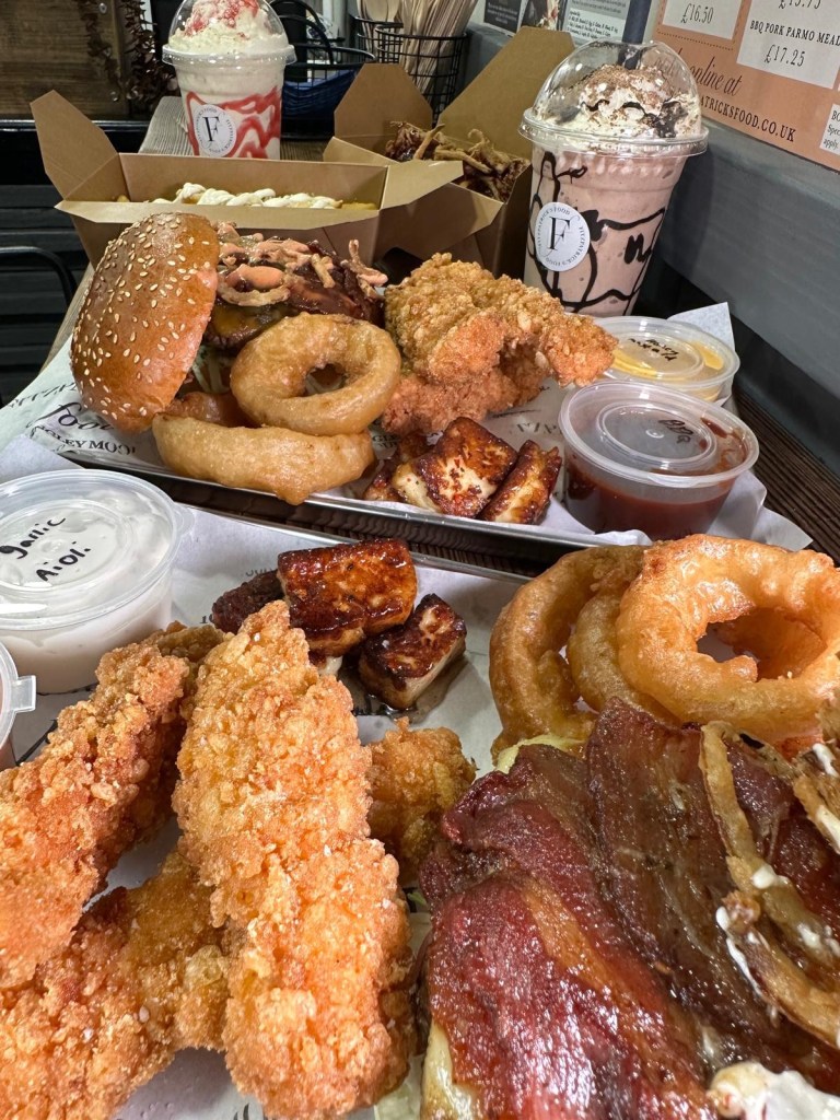A feast of gourmet burgers, loaded fries, crispy chicken goujons, onion rings, and signature dips served at Fitzpatrick’s Food in Durham.