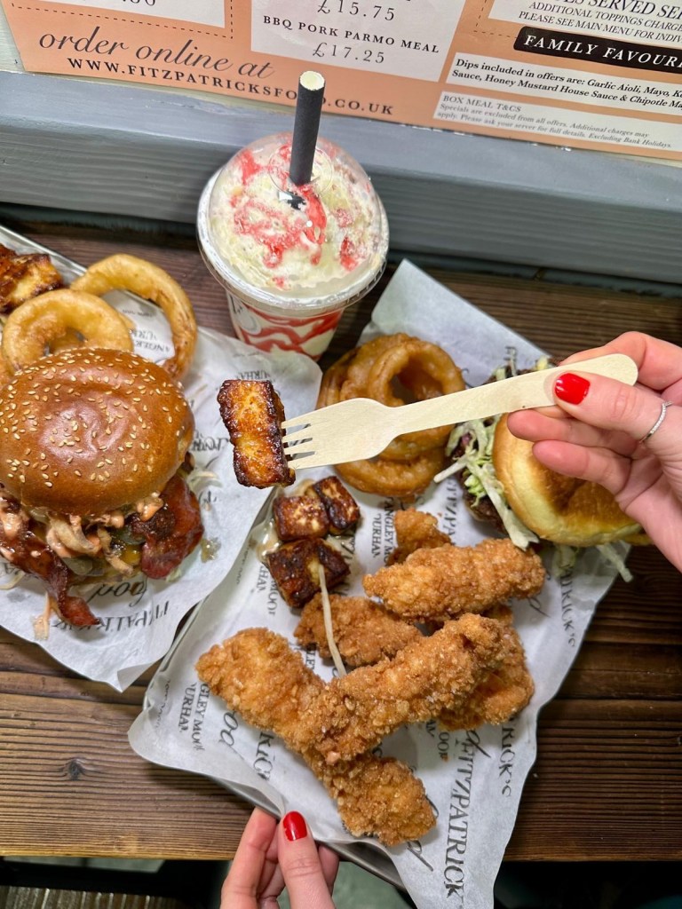 A feast of gourmet burgers, loaded fries, crispy chicken goujons, onion rings, and signature dips served at Fitzpatrick’s Food in Durham.