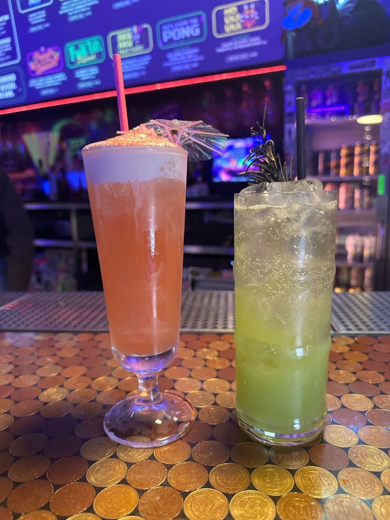 A vibrant cocktail with a rich blood orange flavor, topped with a smooth cream layer, served in a stylish glass at NQ64 Newcastle.