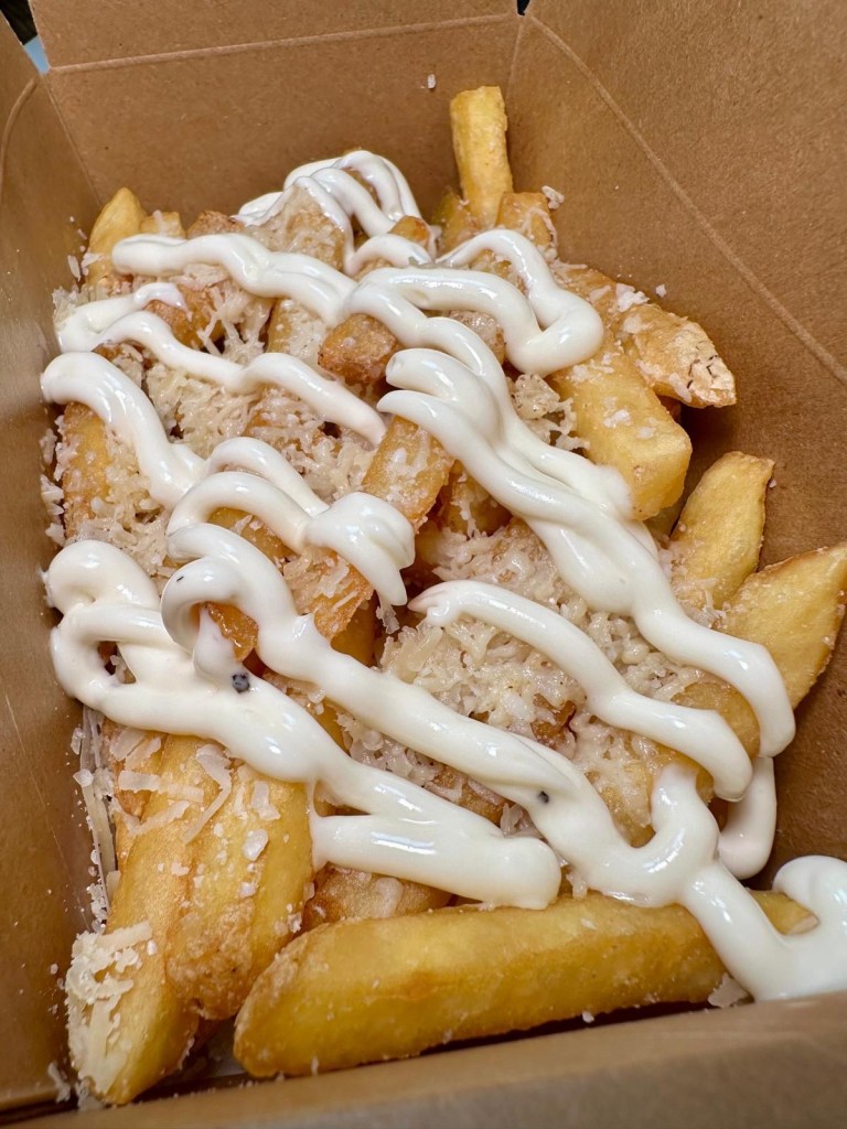 Golden, crispy skin-on fries topped with Parmesan cheese and drizzled with homemade truffle mayo.