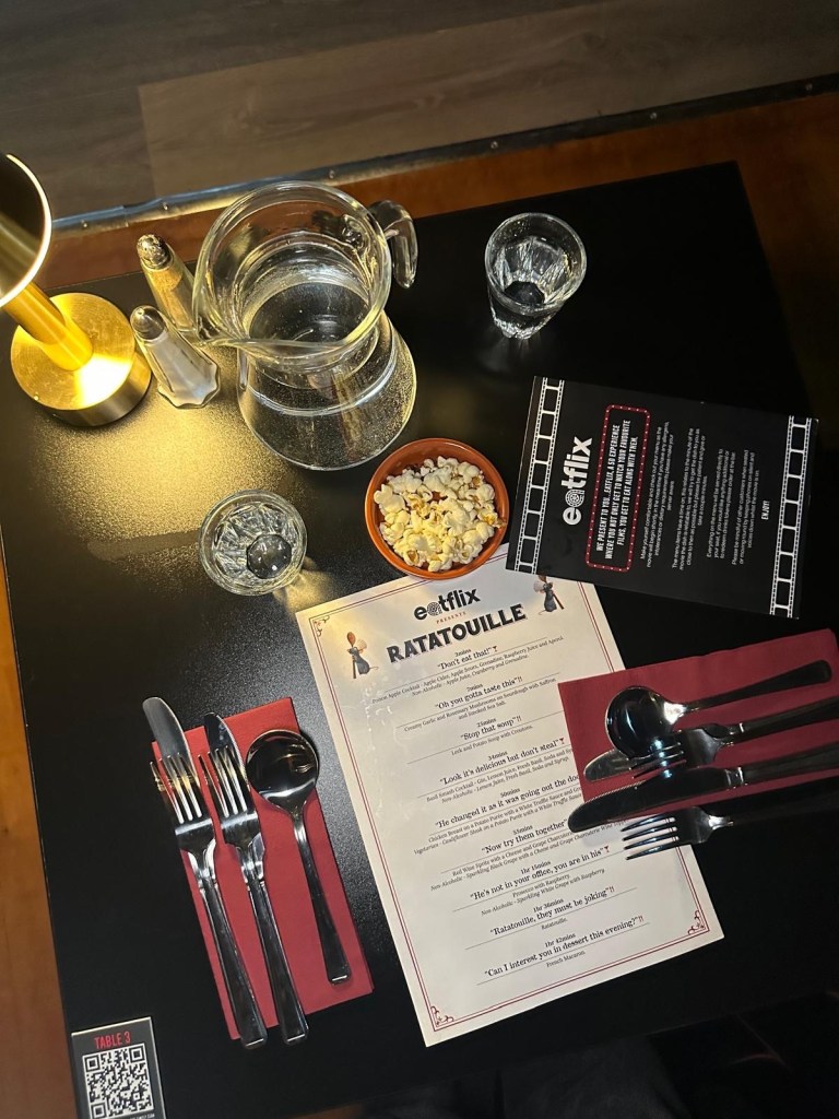 Cozy seating options at Eatflix, including plush sofas, armchairs, and high tables.