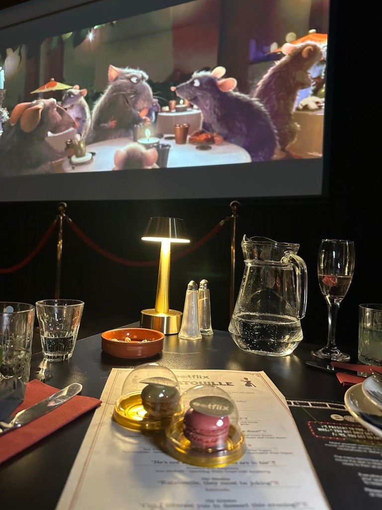 A delicate French macaron topped with edible Eatflix logo paper, served as a sweet finale.