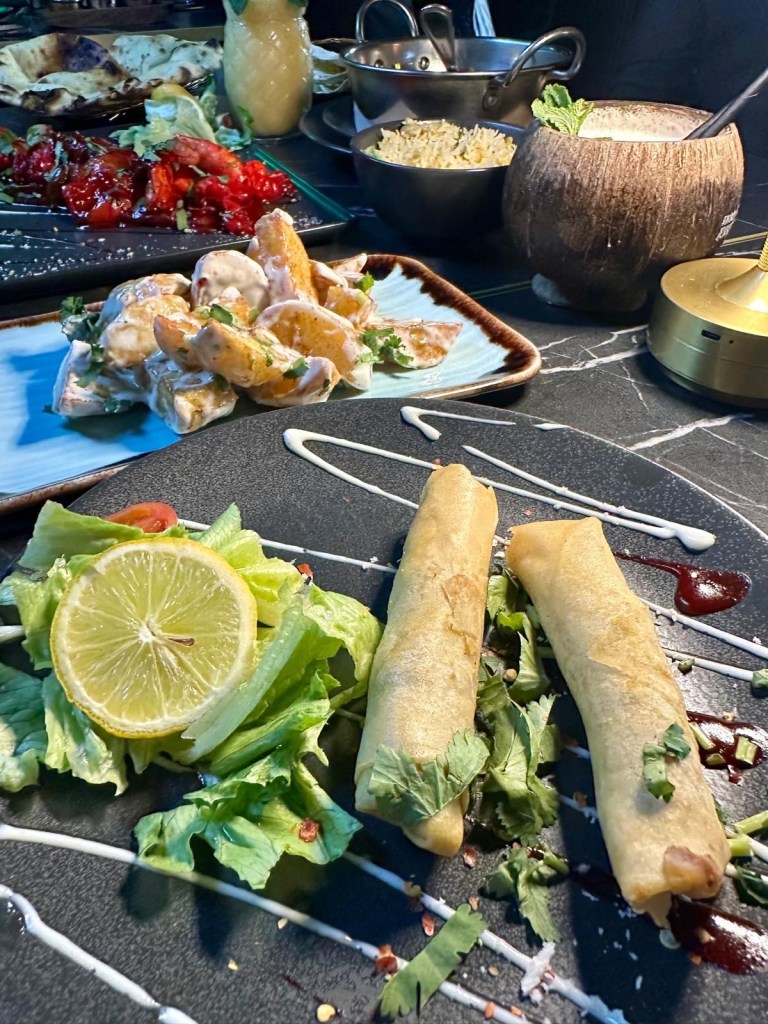 Crispy golden fries coated in a rich, flavorful garlic sauce, a customer favorite at Ester’s Lounge.