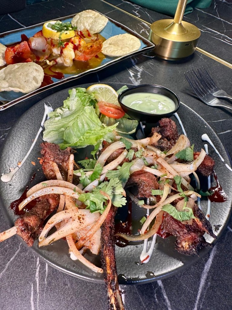 Sizzling, spice-marinated lamb chops served with fresh salad and mint sauce. A fragrant and hearty starter.