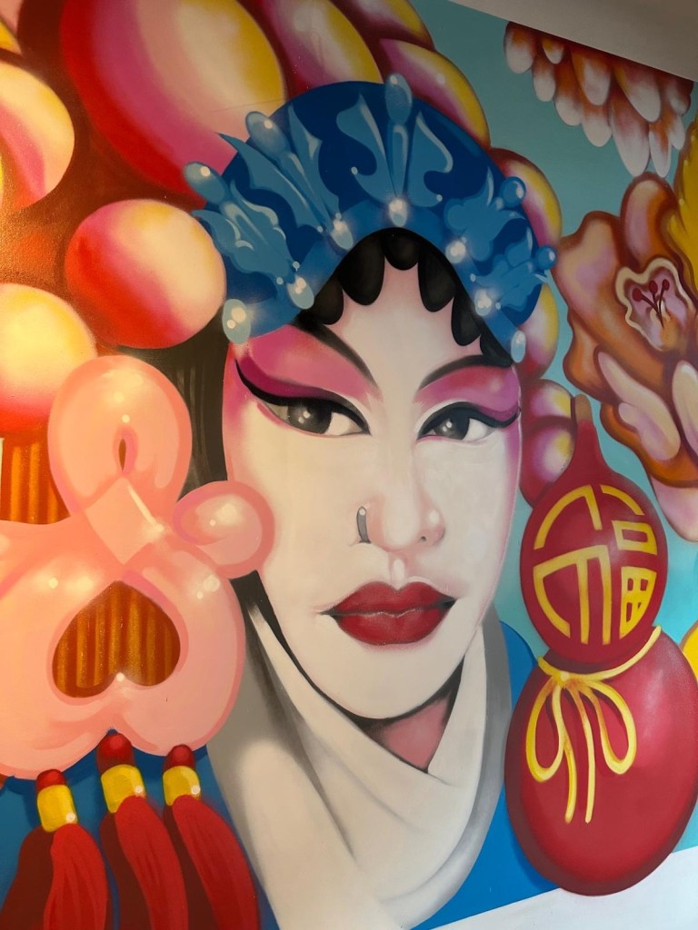 The bright and airy interior of Malatang Express in Durham, featuring stylish wall art and modern seating.