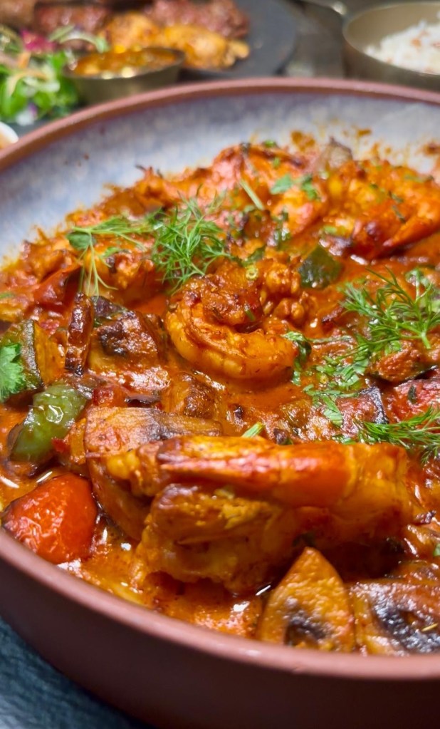 King Prawn Casserole at Lezzet Newcastle, with large prawns, cream, garlic, tomato sauce, peppers, and onions, served with rice.