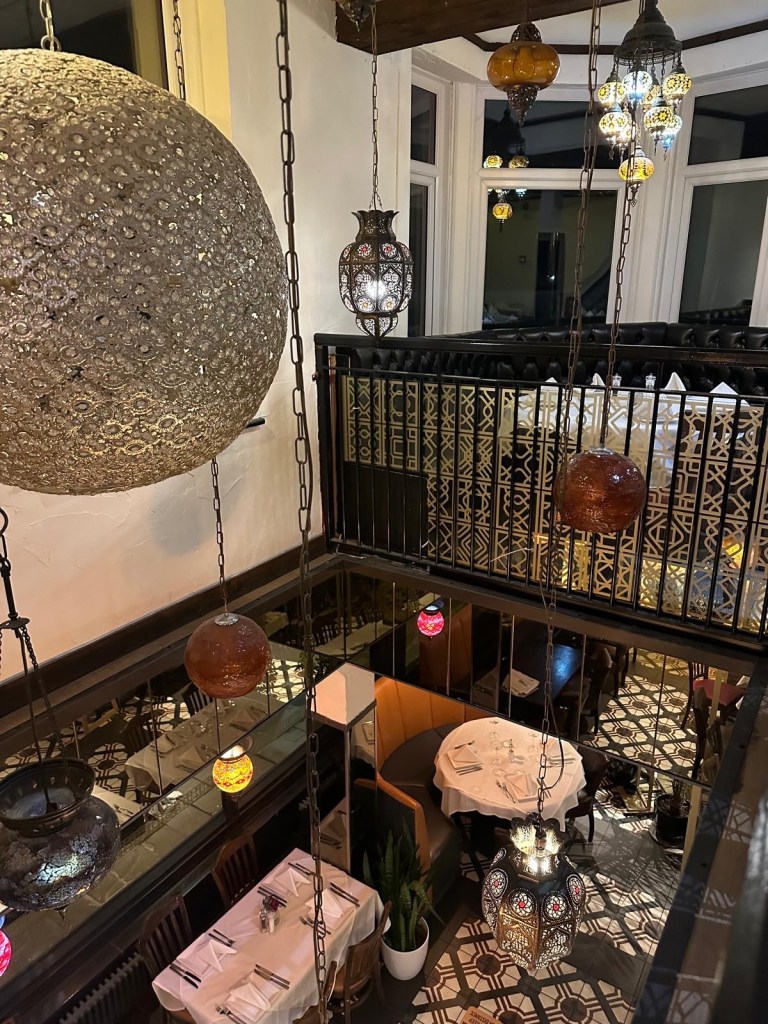 The elegant interior of Turknaz Restaurant, featuring warm lighting, traditional Turkish decor, and cozy seating by the seafront.