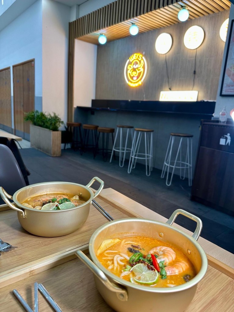 A variety of fresh seafood ingredients, including prawns, fish balls, squid, and mussels, ready to be added to a Malatang hot pot.