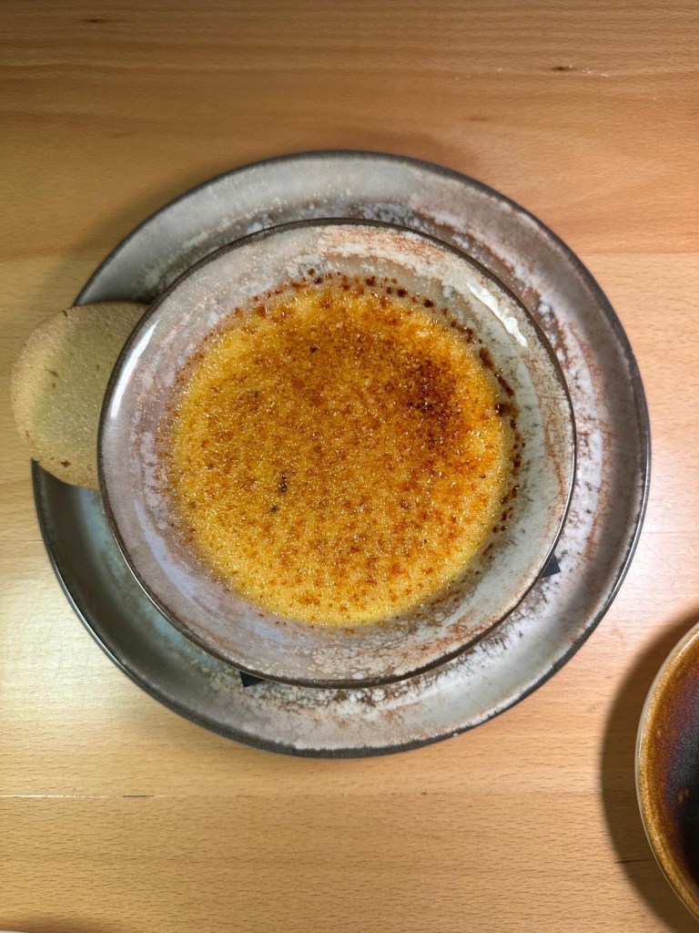 A caramelized crème brûlée infused with Madagascan vanilla and Tácnbora whisky, served in a classic ramekin.