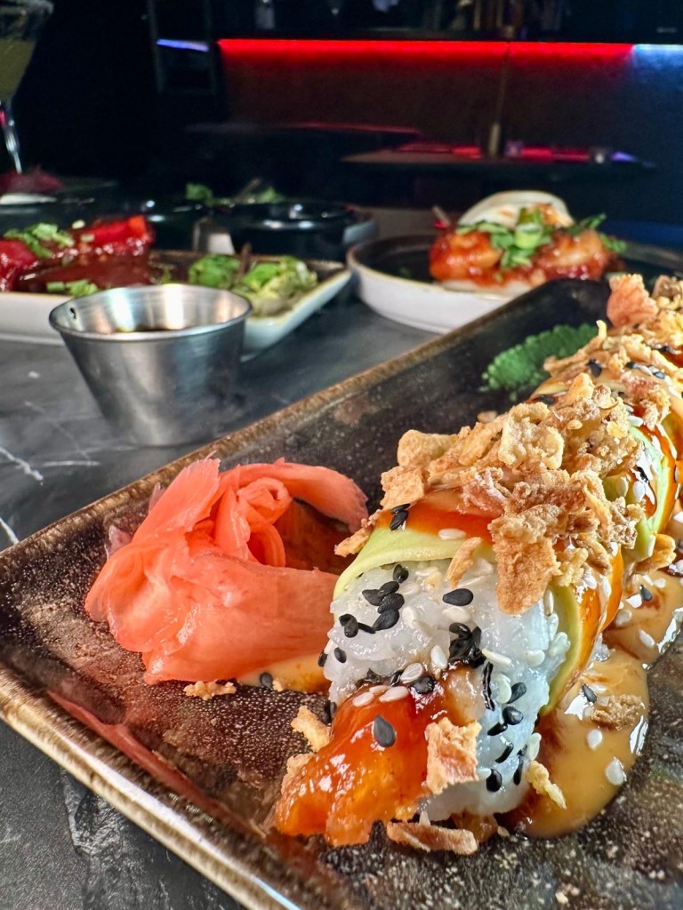 A beautifully plated dynamite prawn dragon roll sushi, topped with avocado and drizzled with dynamite sauce at The Chamber South Shields.