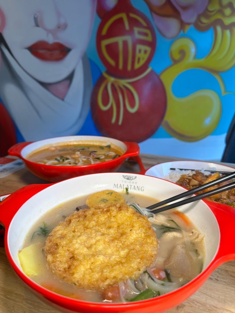 An incredible feast at Malatang Express, showcasing a variety of Malatang bowls, bento boxes, and vibrant side dishes, served fresh and ready to enjoy.