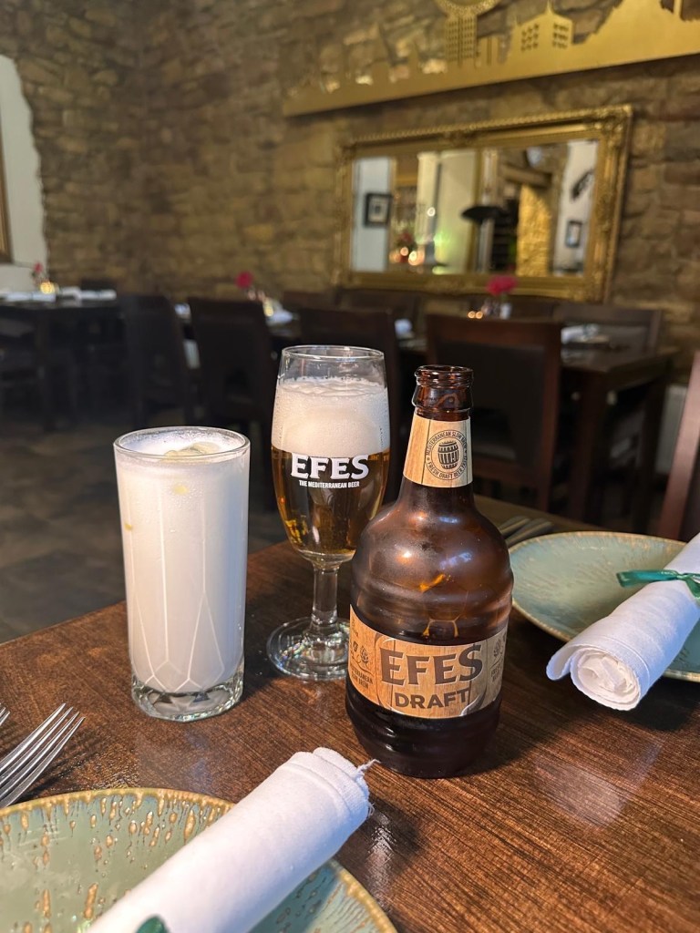 A glass of cold beer and a traditional Turkish ayran drink at Lezzet Newcastle.