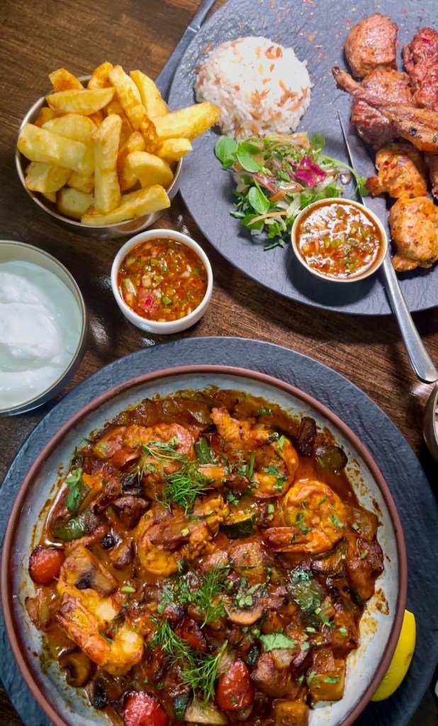 King Prawn Casserole at Lezzet Newcastle, with large prawns, cream, garlic, tomato sauce, peppers, and onions, served with rice