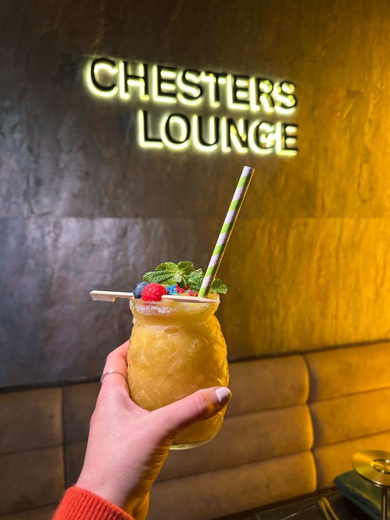A tropical passion fruit and mango frozen cocktail served in a tall glass at Chester’s Lounge.