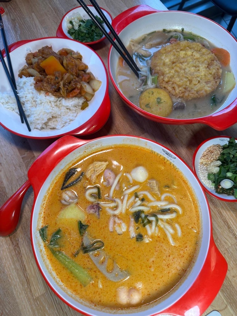 An incredible feast at Malatang Express, showcasing a variety of Malatang bowls, bento boxes, and vibrant side dishes, served fresh and ready to enjoy.