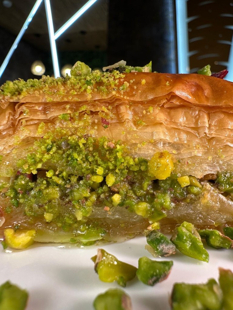 Pistachio baklava served with honey and filo pastry