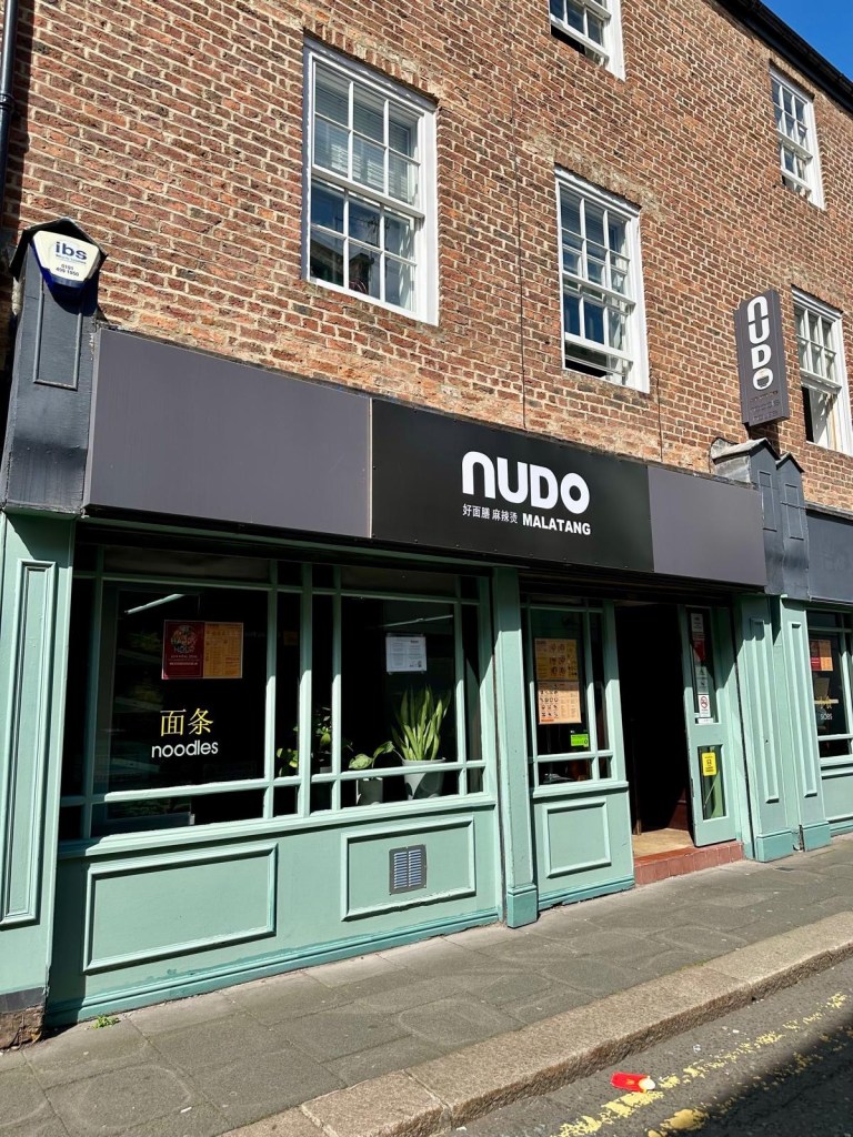 The exterior of Nudo Malatang in Newcastle, showcasing its inviting storefront and signage.