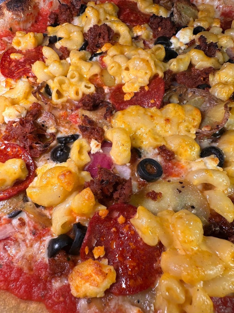 A freshly baked pizza with bubbling cheese and a crispy crust at Pizza Punks.