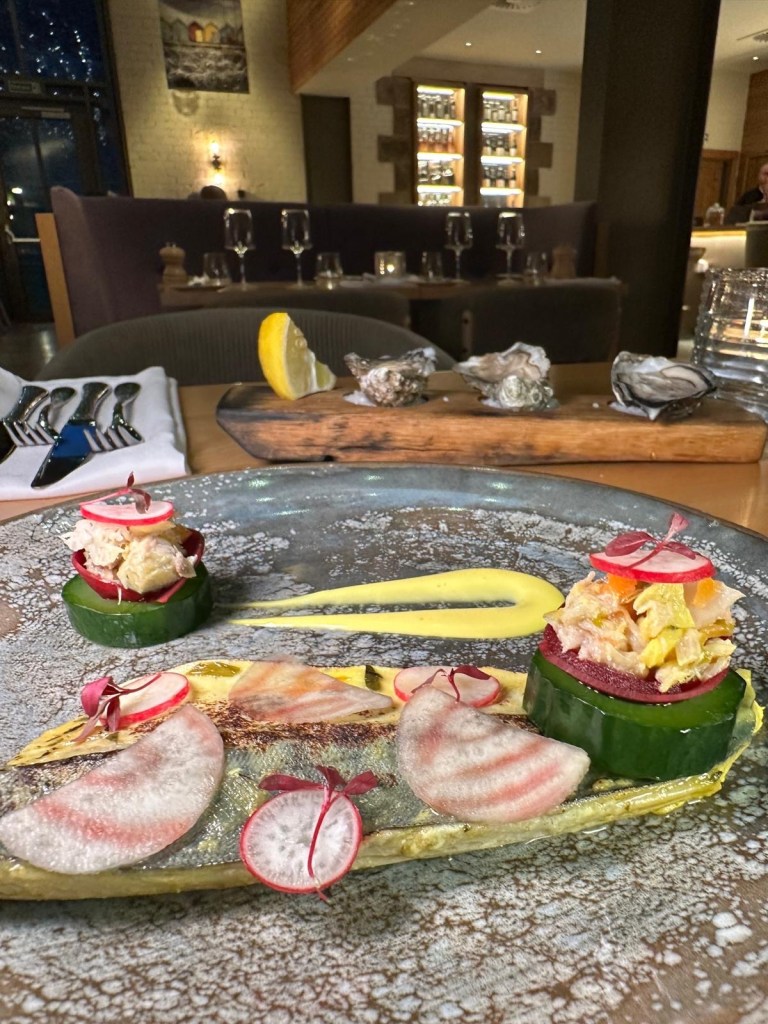 A beautifully plated dish of mackerel escabeche, topped with silky saffron mayonnaise and served with crisp sourdough and cucumber.