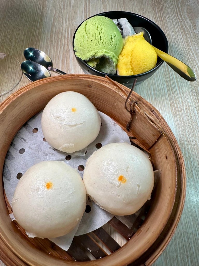 A selection of delicious Asian-inspired desserts, including steamed custard baos and a trio of premium ice creams.
