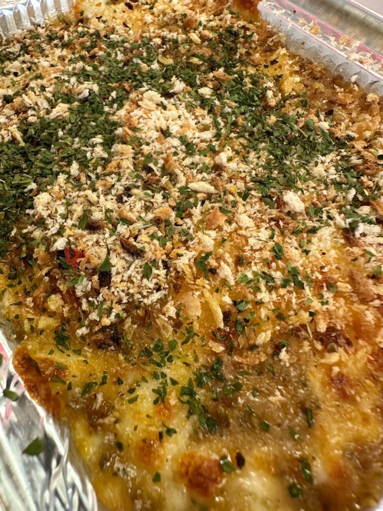 Soft, freshly baked dough balls topped with melted cheese and seasonings, served warm for a satisfying bite.