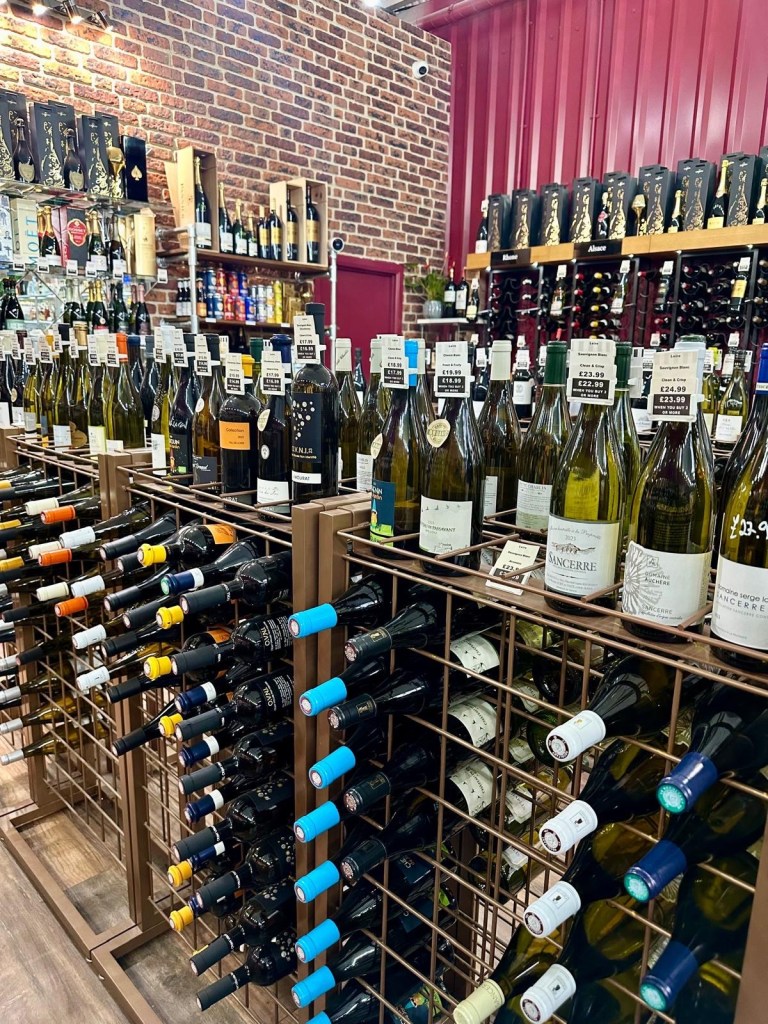 Shelves lined with an impressive selection of wine bottles from around the world at Newcastle Cavavin.