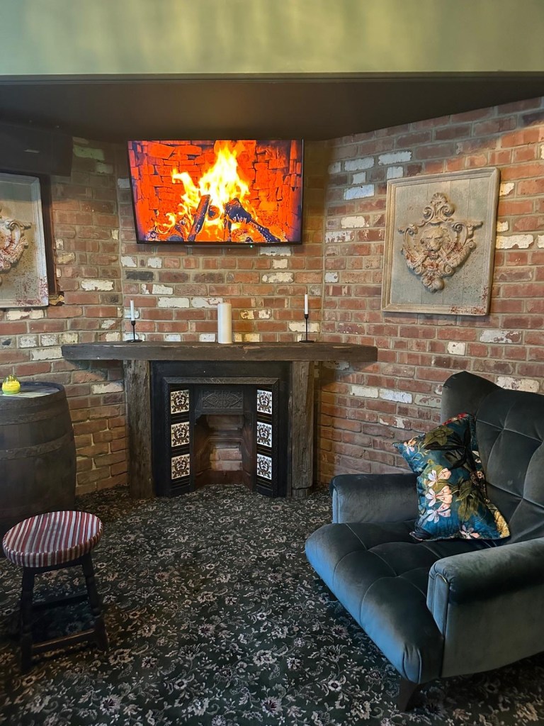 A warm, inviting Irish pub interior featuring Guinness branding, wooden paneling, and a lively atmosphere.