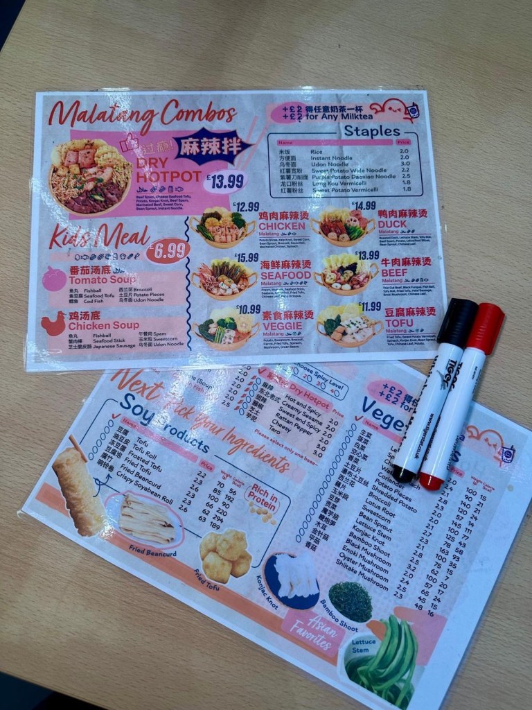 A close-up of the Weis Malatang menu, displaying a variety of broth options, proteins, vegetables, and noodles for a customizable hot pot experience.