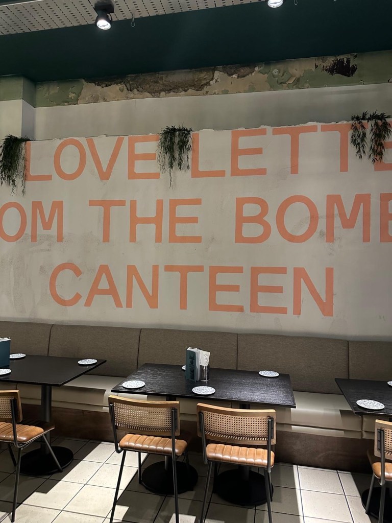 A stylish dining booth with plush seating, moody lighting, and elegant decor at Dakwala Bombay Canteen.