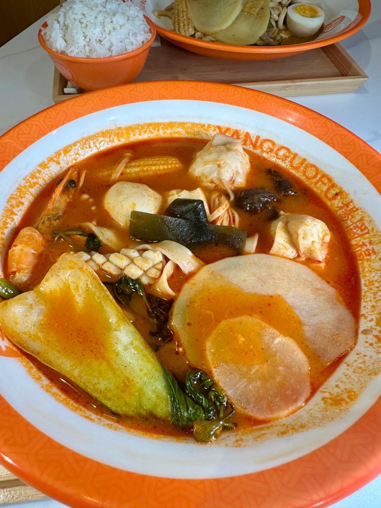Freshly cooked Malatang bowl with king prawns, homemade noodles, and vegetables in sweet and sour broth