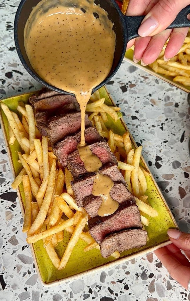 Flat iron steak with crispy seasoned fries and peppercorn sauce at River Bar Washington