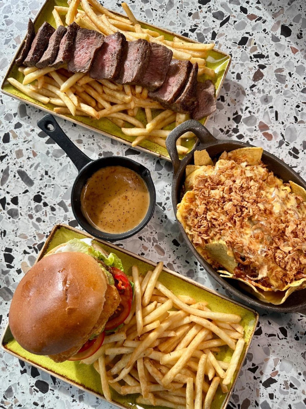 Steak and frites, green Mexican burger with fries, and pulled pork loaded fries at River Bar Washington