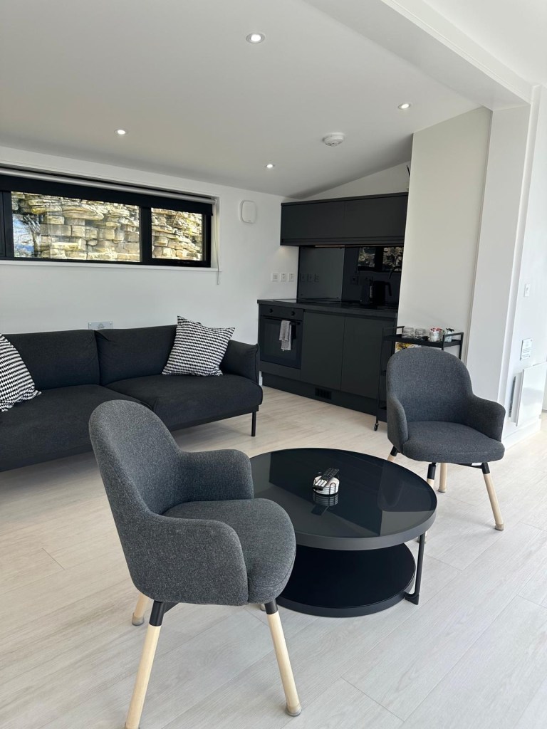 Warm and welcoming open-plan lodge interior with kitchen, dining, and lounge space.